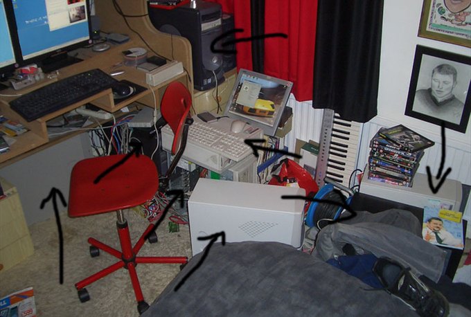 A cluttered bedroom in 2004 with several desktop PCs and monitors stacked around a desk